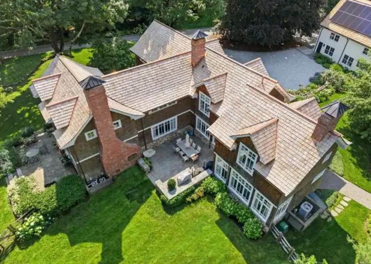 Aerial view of a large house with a cedar shake roof