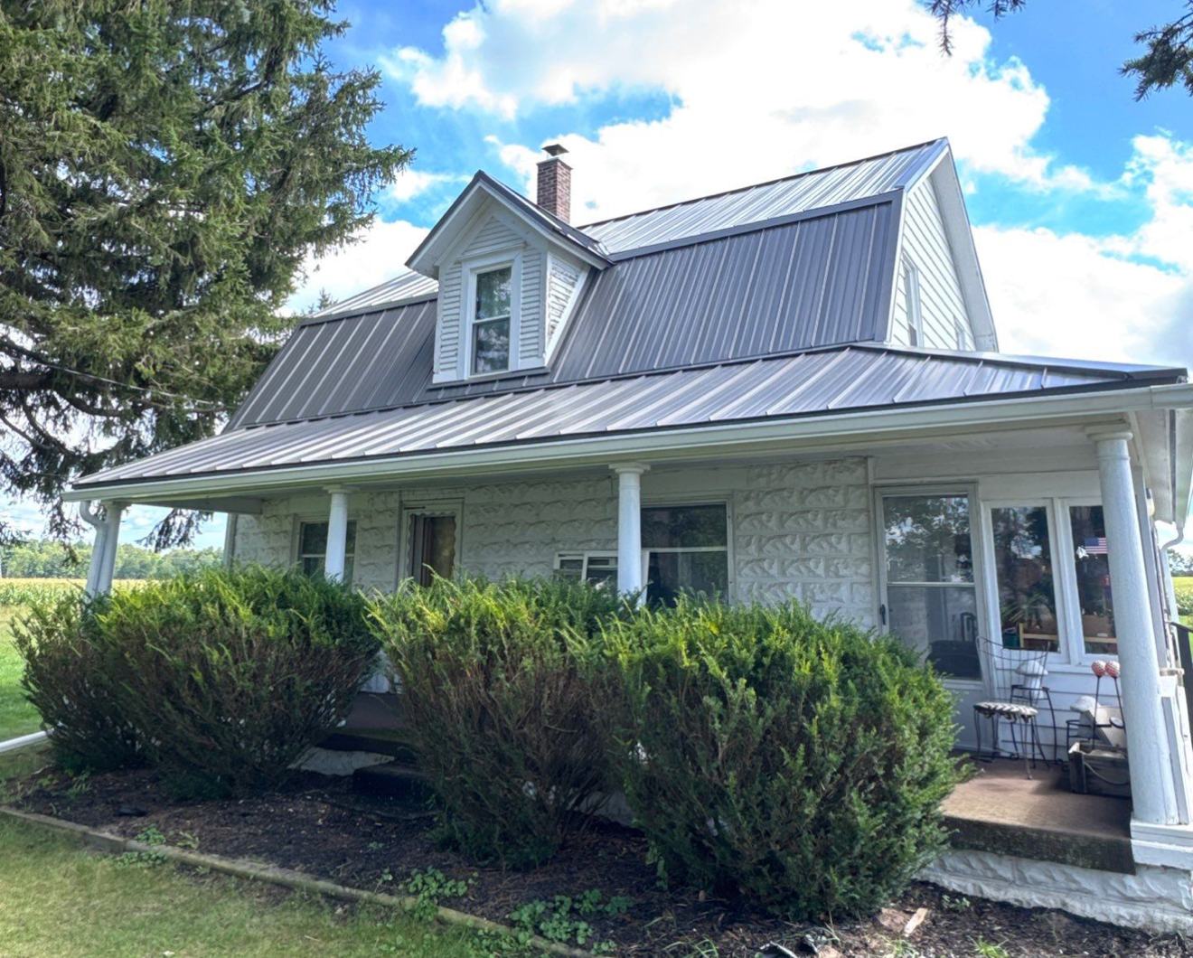 Farmhouse with a new metal panel roof